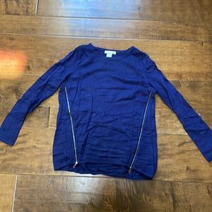 Blue long-sleeve sweater with zips on each side.